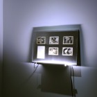 Eric Baudelaire, <em>The Makes (Out of Desperation)</em>, found Japanese film stills, page torn from That Bowling Alley on the Tiber by Michelangelo Antonioni, Plexiglas, steel and fluorescent tubing, 2009