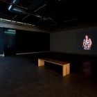 Installation View: Jannicke Laker, <em>Running Woman</em>, HD Video, 2006 and Paolo Canevari, <em>Bouncing Skull</em>, Video, 2007. Documentation by Morris Lum.