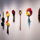 Christine Negus, <em>oh, those sad lonely beasts! (cosmos)</em>, 4 wreaths, 4 falls and 1 braid with artificial hair, ribbon and artificial flowers, 2011-12. Documentation by Morris Lum.